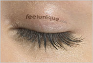 A tattoo on a woman's eyelid advertises a web site
