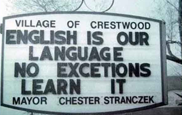 Sign reading "ENGLISH IS OUR LANGUAGE NO EXCETIONS LEARN IT"