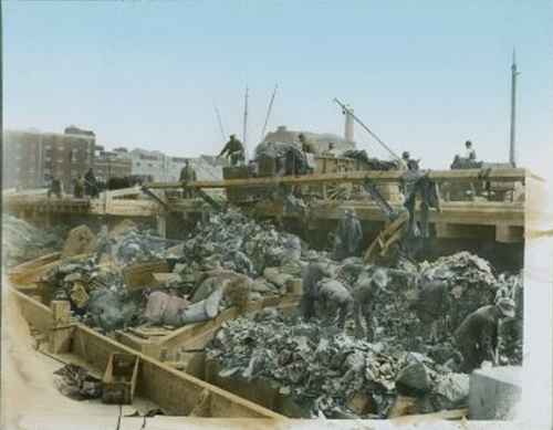 Men working on garbage barge ca. 1900