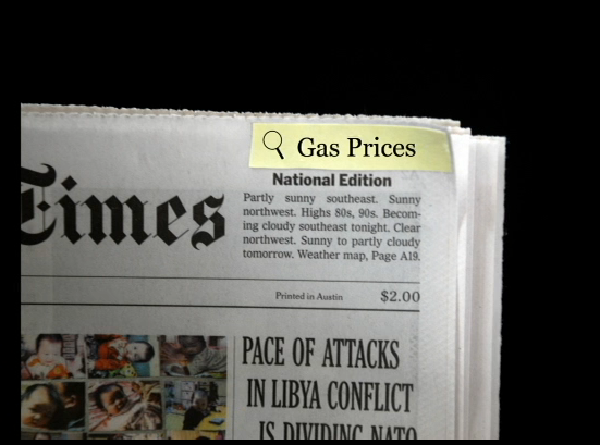 a newspaper with "gas prices" highlighted as if on a digital reader