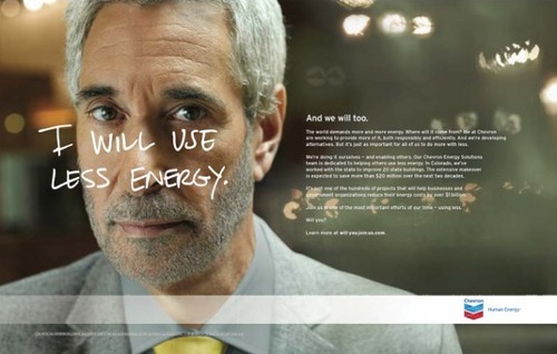 Business man stands against unfocused background; text over him: "I will use less energy." Text to right: "And we will too."