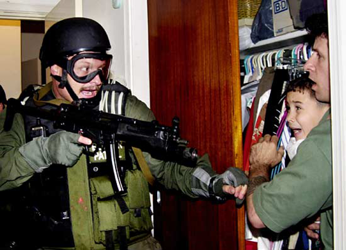 Elián González as he is pulled from a closet