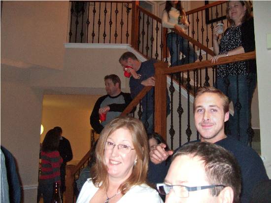 This image is a picture of a holiday party in which Ryan Gosling's head has been placed on another man's body.