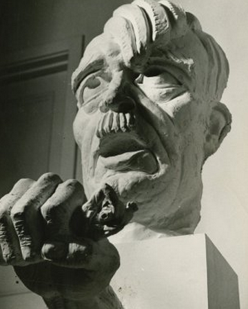 Sculpture of Hitler crushing a person in his hand