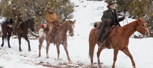 Image from True Grit of characters riding horses in the snow