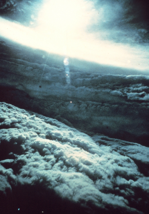 Image of hurricane interior; white wall of cloud set against grey clouds in background