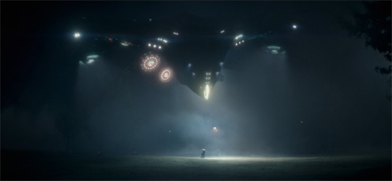 A spaceship whose sleek black body and glowing lights evokes classic Steven Spielberg films abducts the future Starlord.