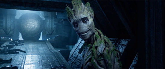 The tree-like Groot smiles gently. Behind him? A pile of dead bodies.