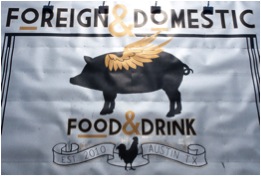 Photo shows exterior of the restaurant Foreign & Domestic, which features a pig with wings.