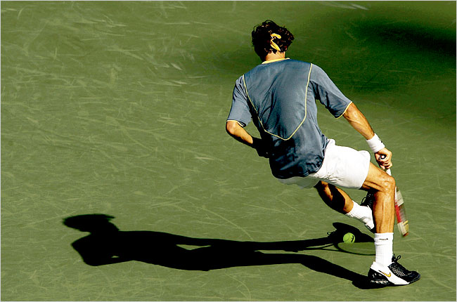 Federer in the middle of hitting a tennis ball