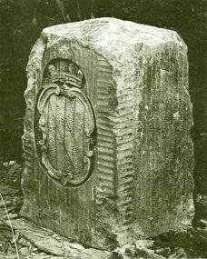 A picture of the Mason-Dixon marker, with the Calvert family of Maryland's coat of arms showing.