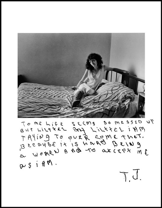 black and white photo of a woman on a bed. She stares defiantly at the viewer. Handwritten text below the photo reads to me life is so messed up but little by little I am trying to over come that. Because it is hard being a woman and to accept me as I am. T.J.