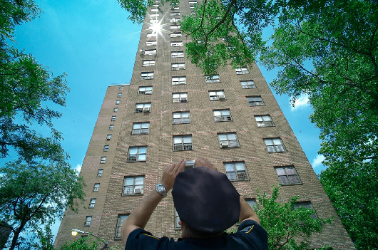 Police officer photographs tall building