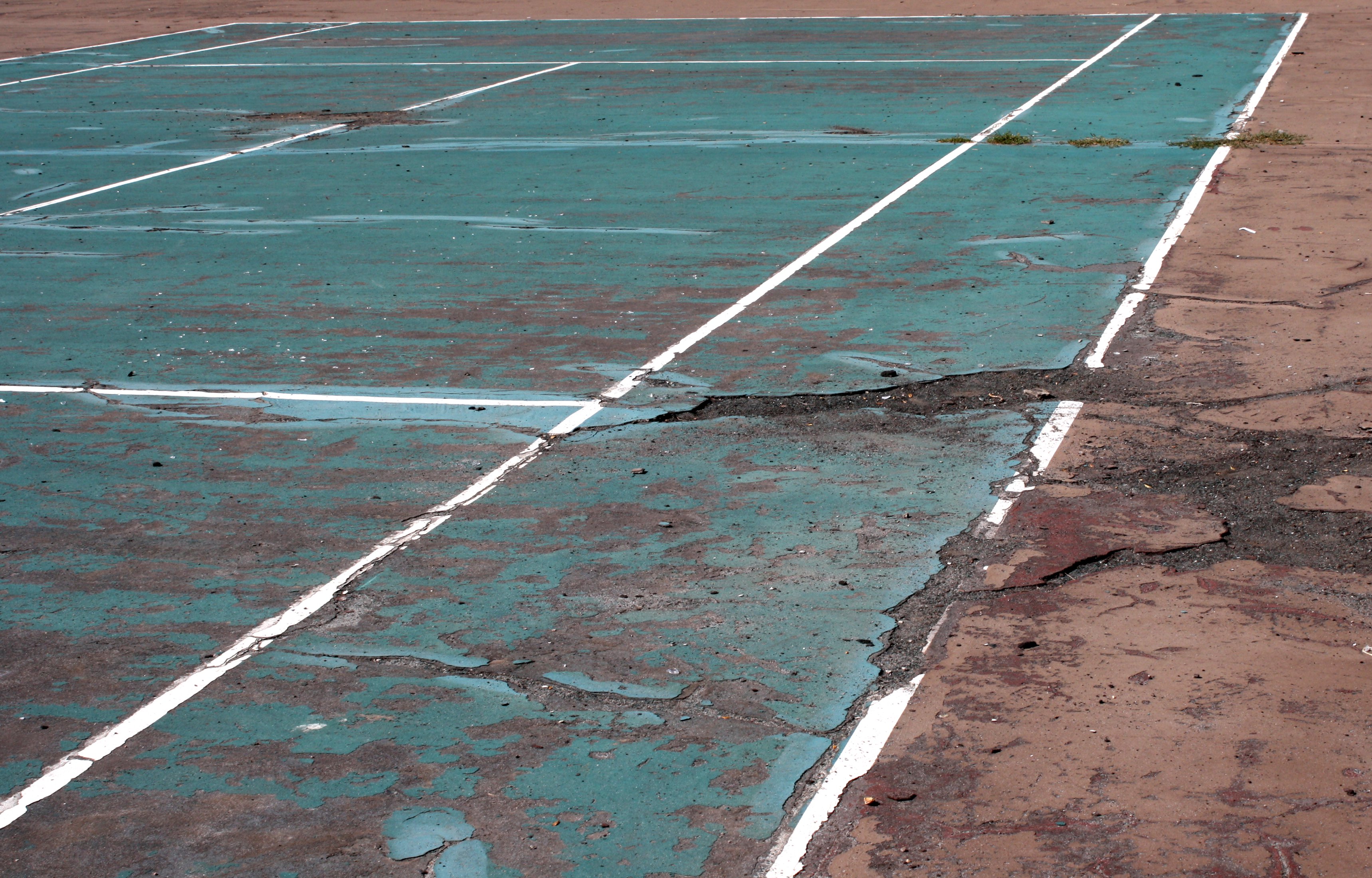Tennis Court in Disrepair (cracked and faded paint)