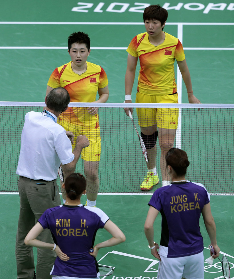 Officials speak to the Chinese and South Korean badmitton teams during the match they deliberately threw at the 2012 Olympic games.
