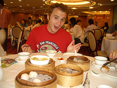 guy eating Asian food at restaurant