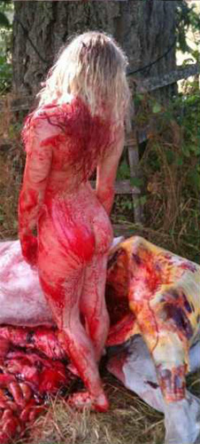 Lottin, naked and bloody, looking at the dead horse. 