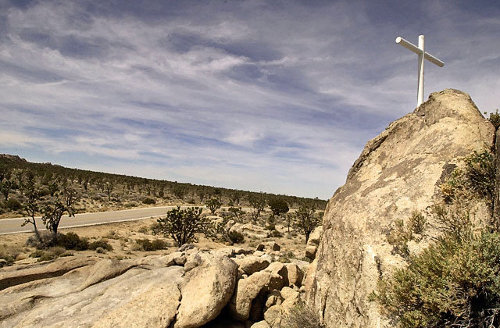 White cross atop desert rock