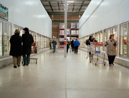 Several people in a frozen food aisle