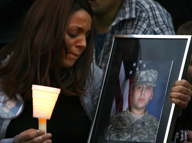 Woman holding photograph at vigil for Fort Hood victim