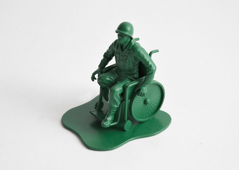 picture of green plastic army man in a wheelchair