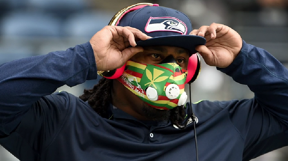 Marshawn Lynch in a multicolored high-altitude breathing mask.